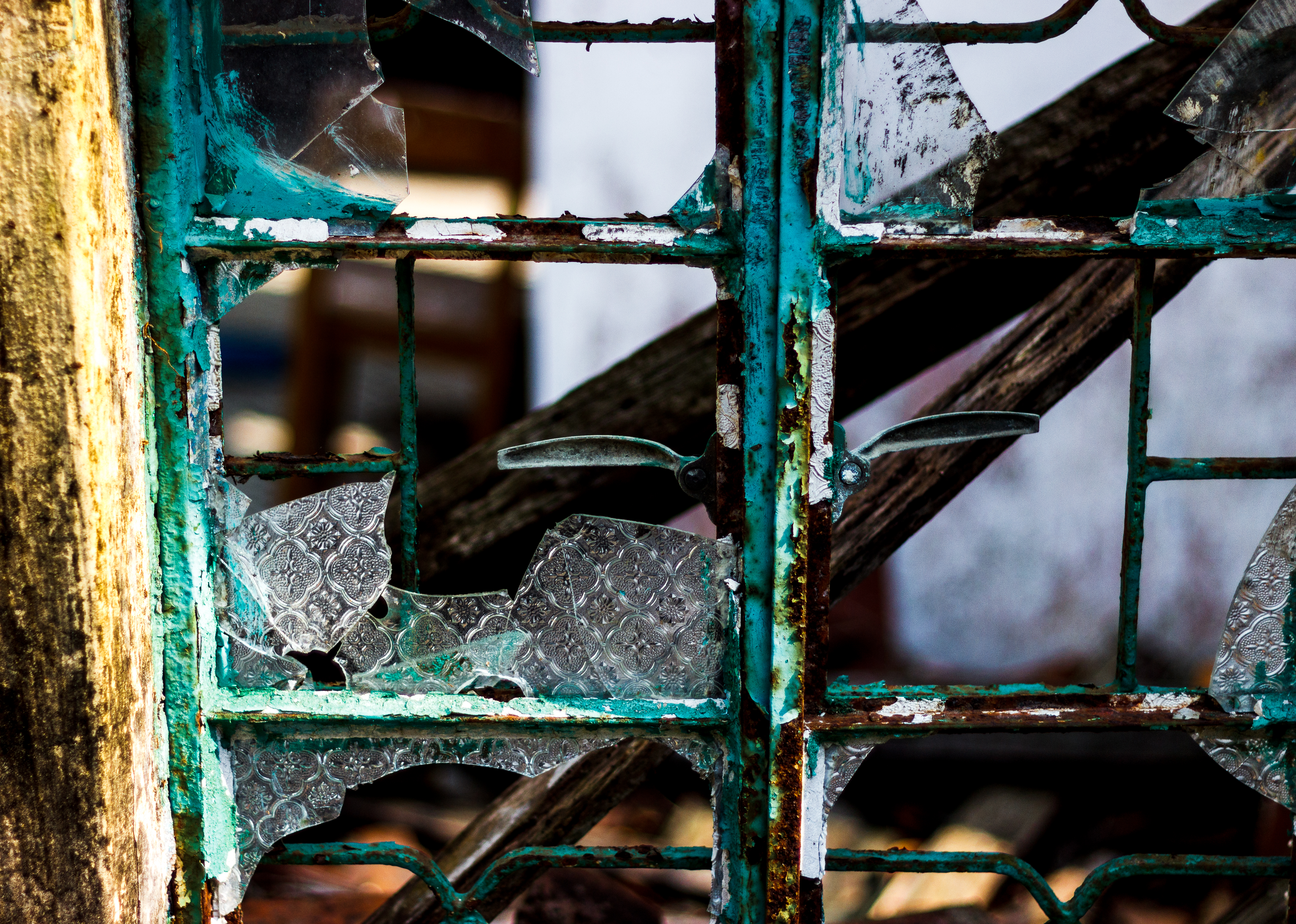 Broken patterned glass in a weathered window frame, Hong Kong